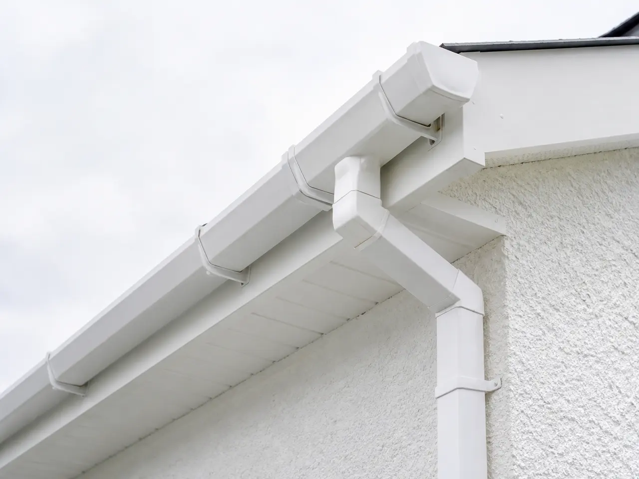 White uPVC guttering against a pale house roofline